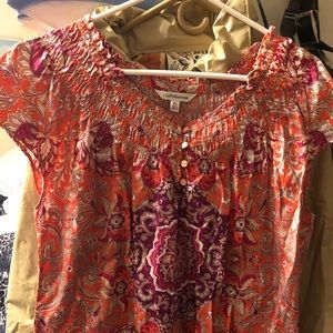 Short sleeve coral, magenta, and tan blouse.